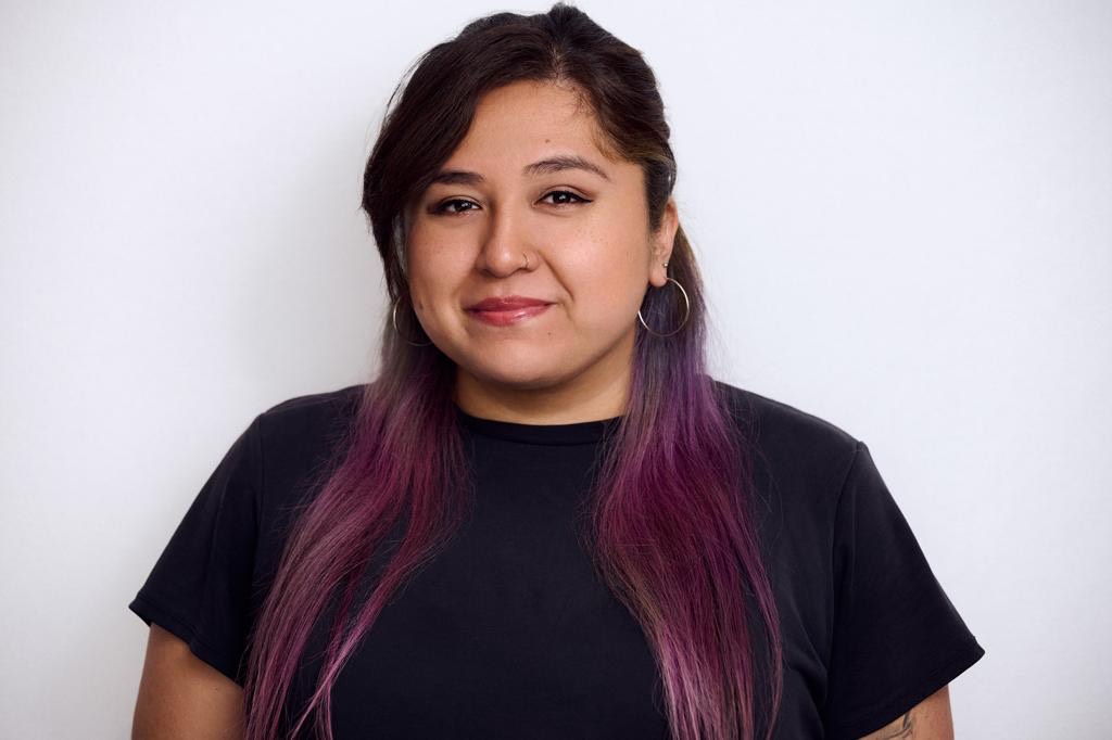 A photo of Edith Ramos on a grey background, wearing a black shirt.
